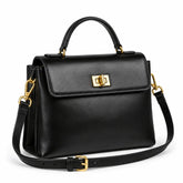 Bolsa Feminina em Couro Preta Louise — vista lateral com alça de mão, tiracolo ajustável e fecho giratório dourado estilo satchel
