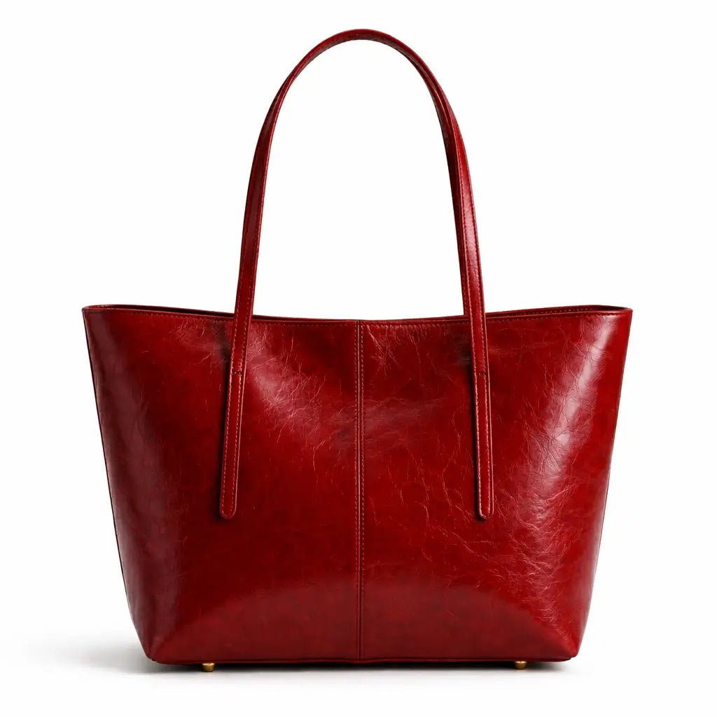 Vista frontal isolada de uma bolsa tote feminina Nualle em couro vermelho tomate, apresentada em um fundo branco puro.